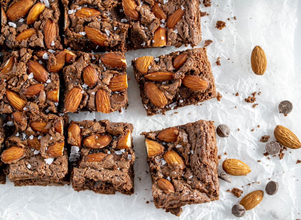 overhead photo of chocolate almond brownies topped with flaky sea salt