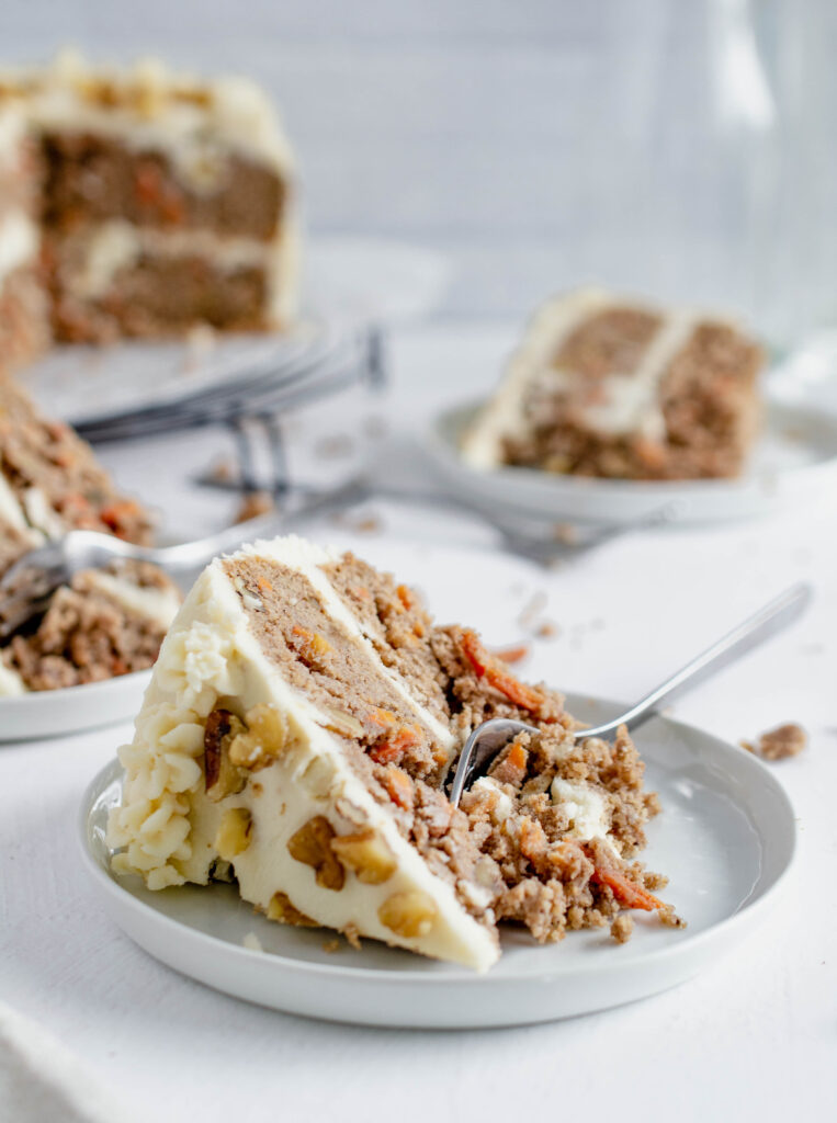 slice of carrot cake topped with walnuts