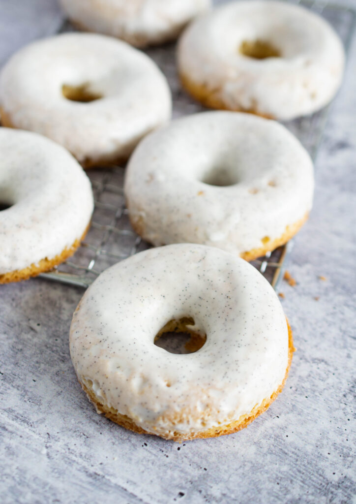 close up image of a vanilla donut with a vanilla bean frosting