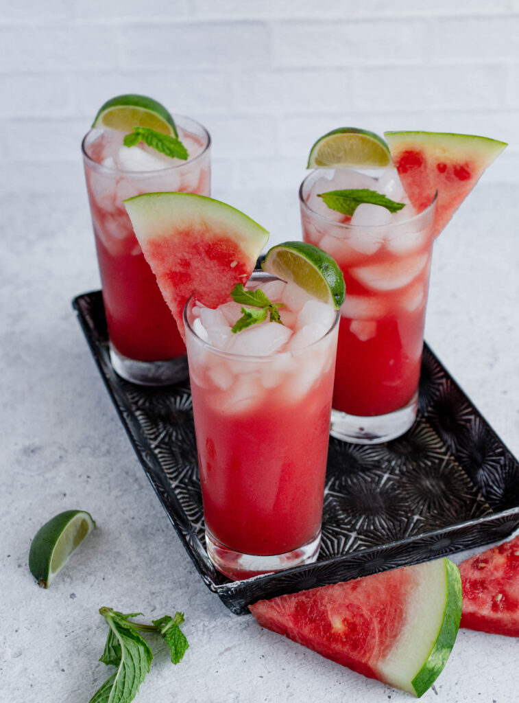 3 glasses of watermelon juice on a serving tray