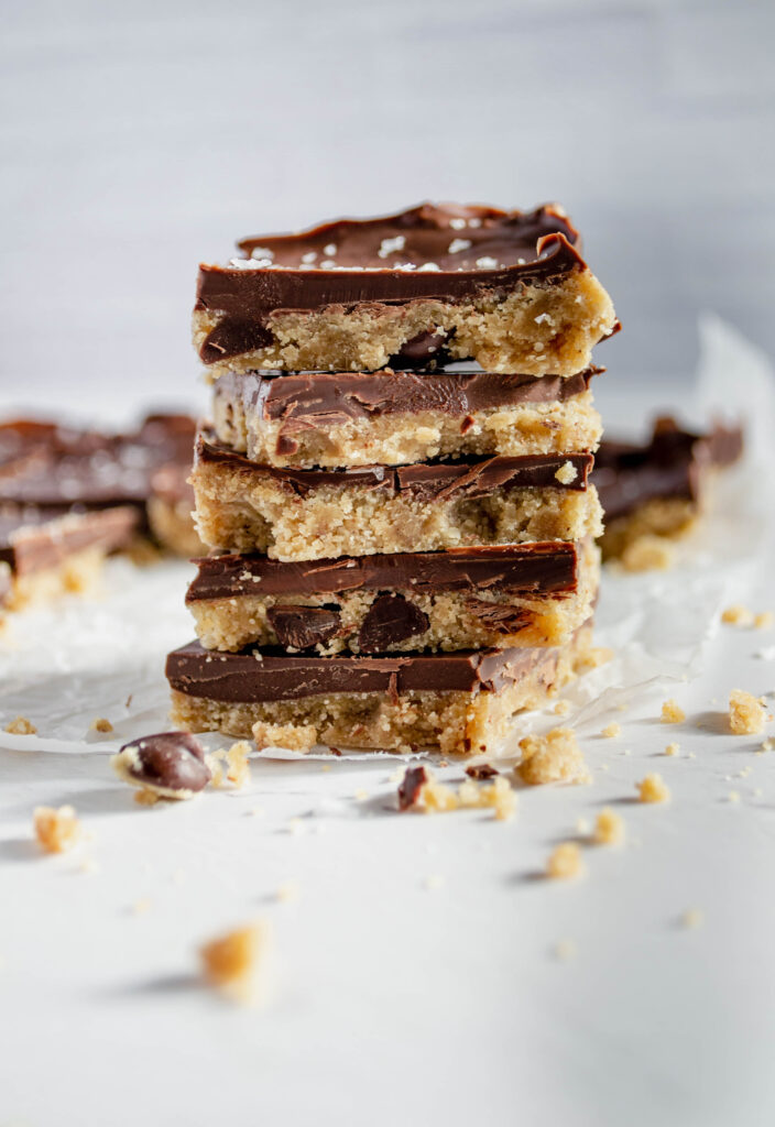 stack of five cookie dough bars with crumbs around the stack