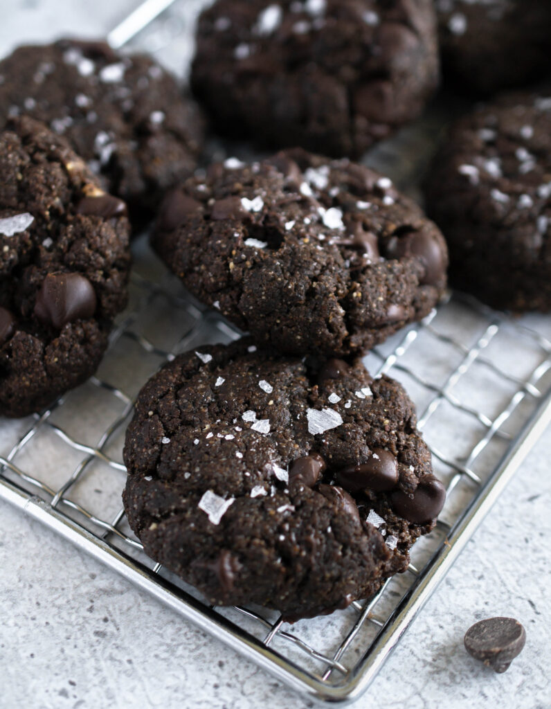 close up photo of double chocolate cookies with flaked sea salt on top