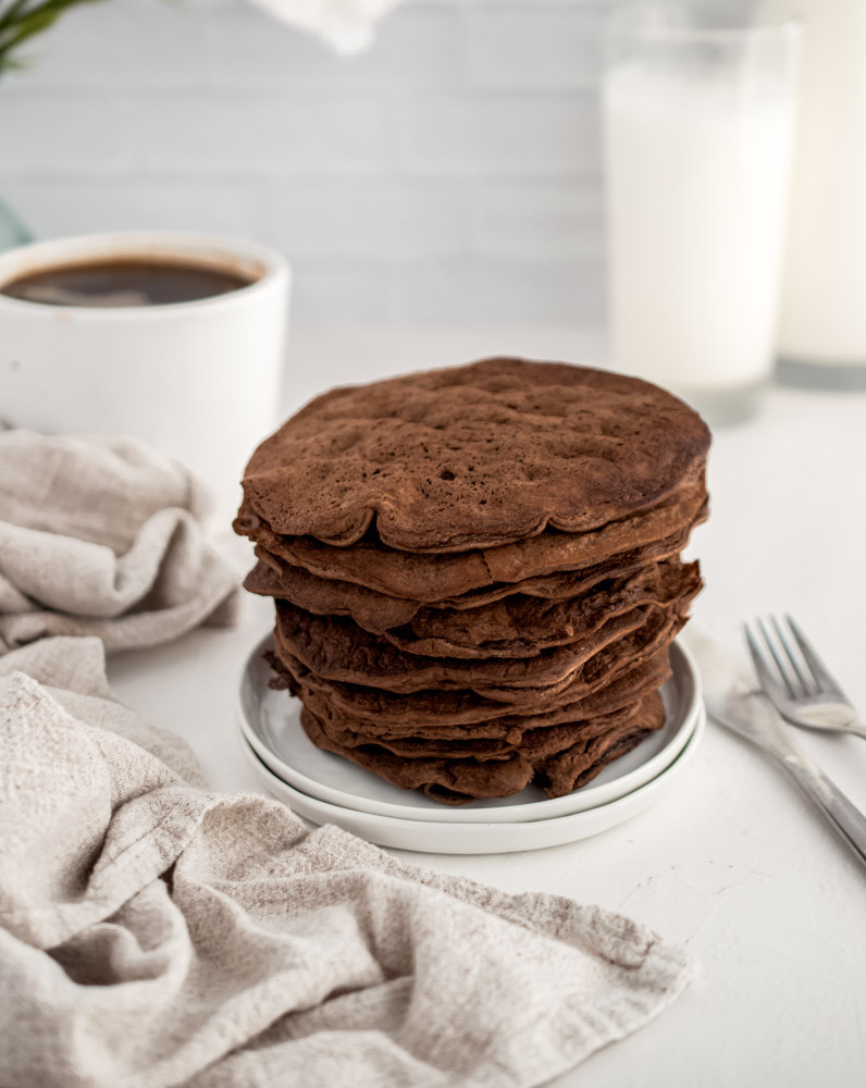 stack of Chocolate Protein Pancakes on a small white plate