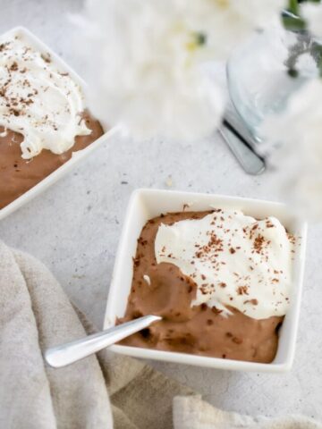 overhead photo Sugar Free Keto Chocolate Pudding topped with whipped cream and chocolate shavings.