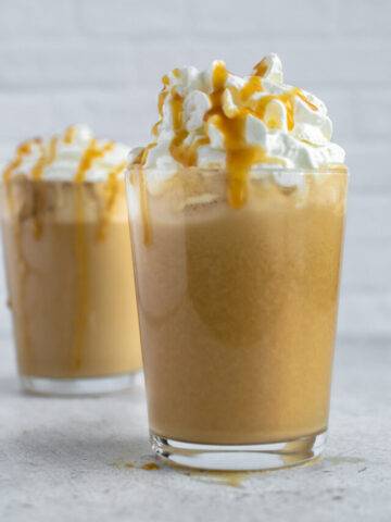 glass of peanut butter coffee topped with whipped cream and caramel sauce