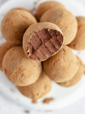 stack of vegan truffles, top truffle has a bite taken out