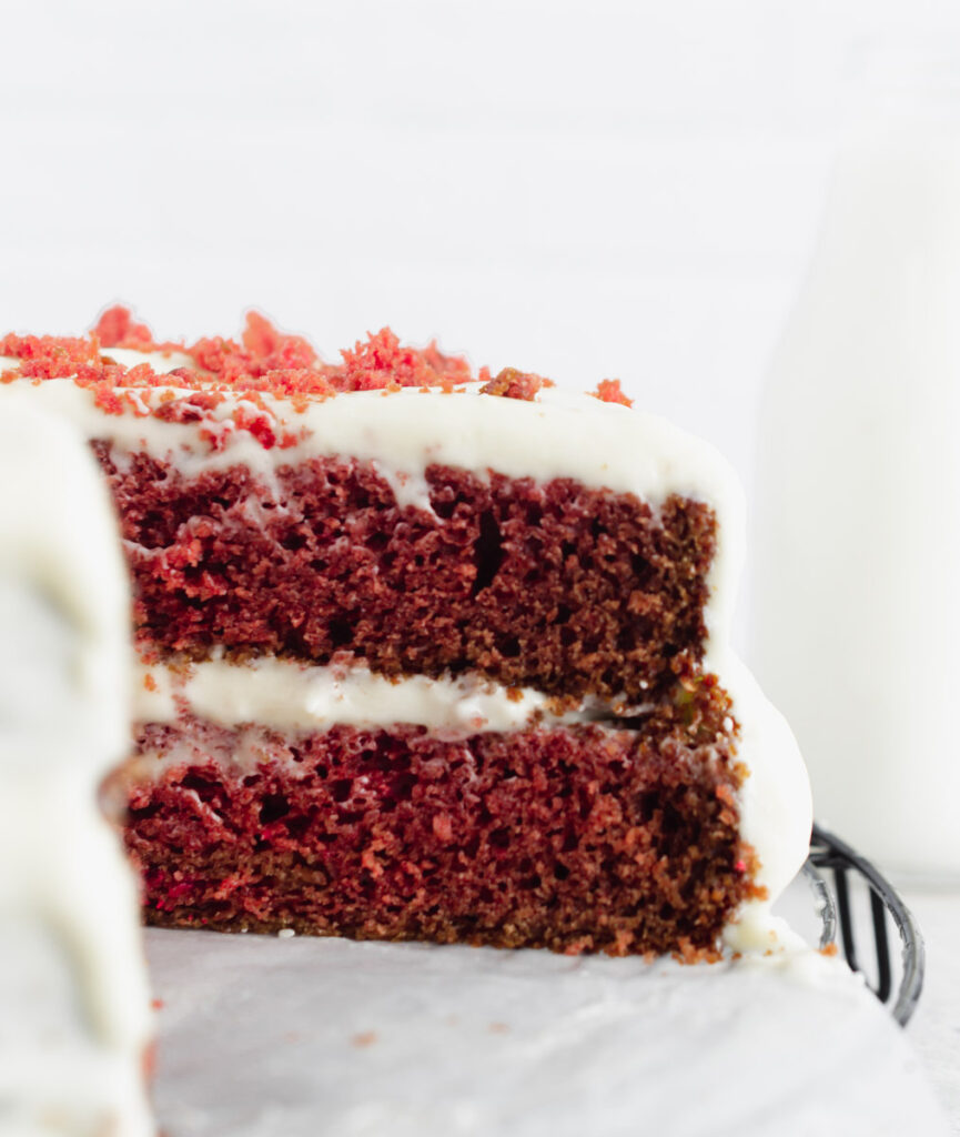 vegan red velvet cake with a slice taken out