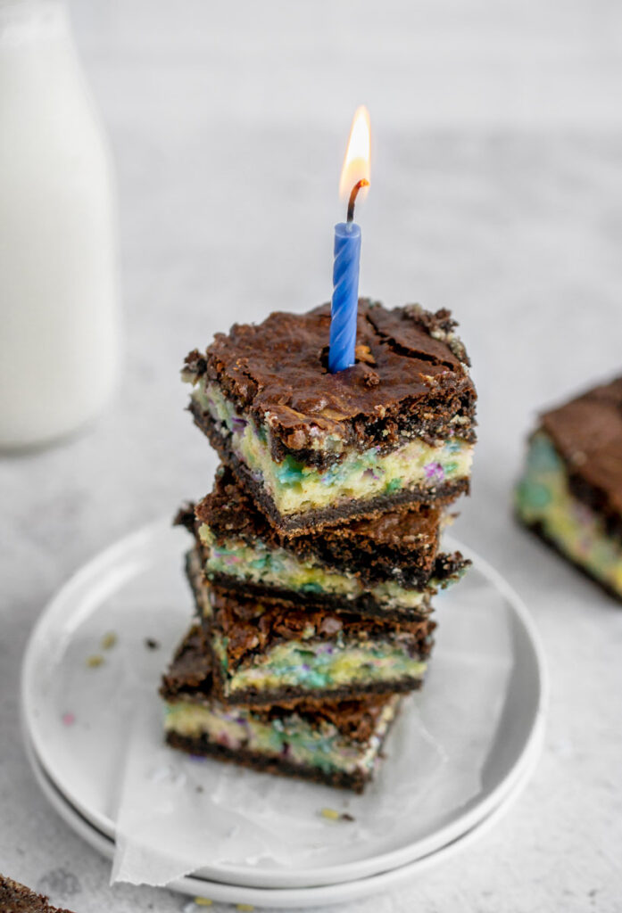stack of birthday brownies with a lit candle