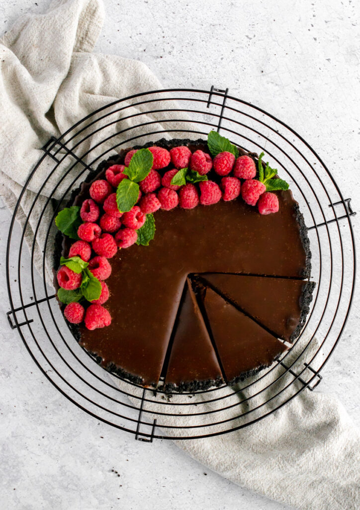 Chocolate Raspberry Tart decorated with raspberries and mint leaves
