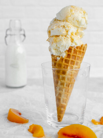 waffle cone filled with peaches and cream ice cream