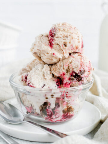 scoops of black forest ice cream in a glass bowl