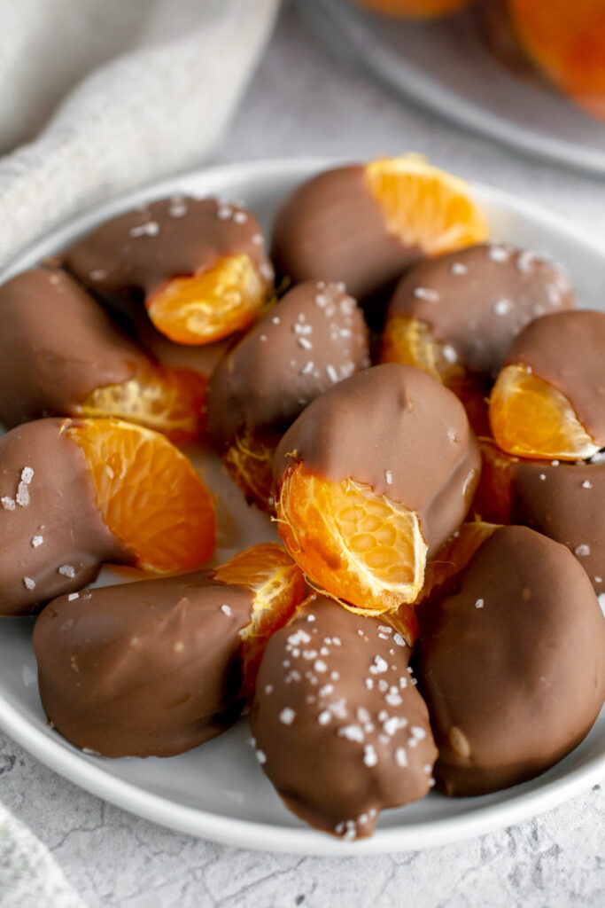 chocolate covered oranges on a white plate