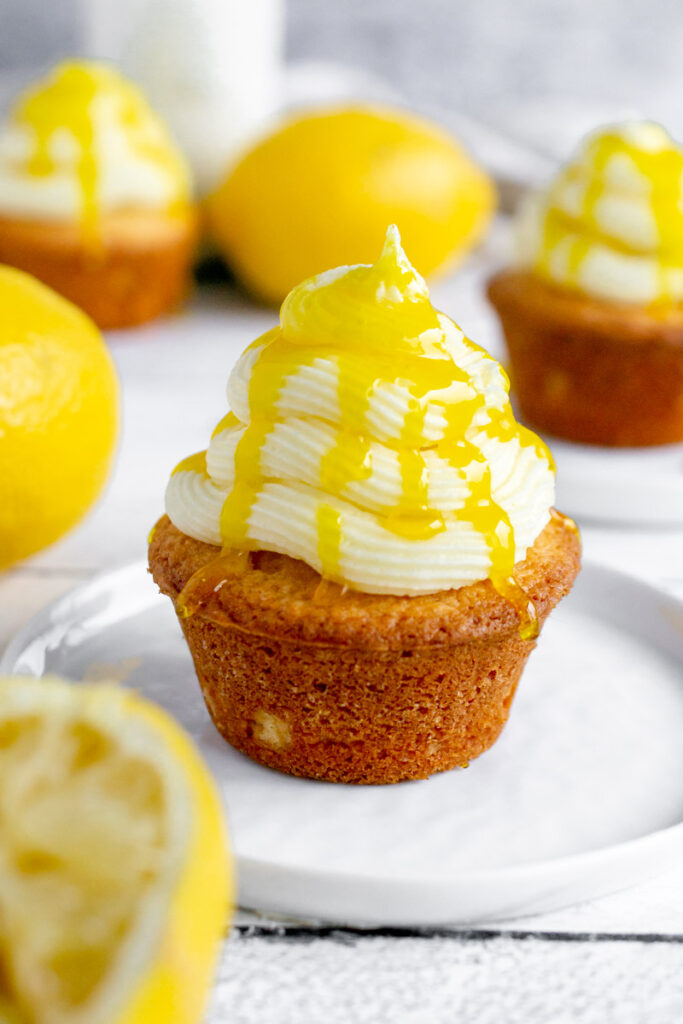 lemon drizzle cupcake on a white plate