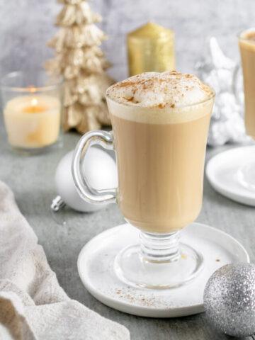 eggnog latte in a glass mug