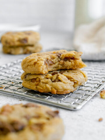 stack of 2 pecan chocolate chip cookies in a cooling rack